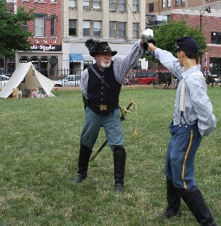 The Colonel and the Corporal demonstrate saber tactics 